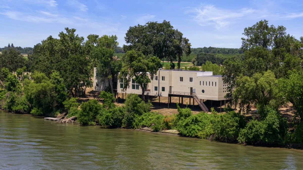 The water-facing side of Sacramento River home features multiple terraces and a private dock on a bend of the Sacramento River.